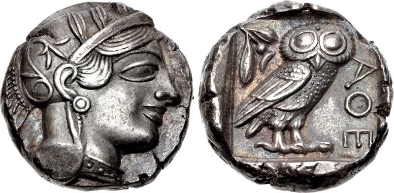 Silver tetradrachm of Athens, 454-404 BC, shown from both sides: the helmeted head of Athena on the obverse, and on the reverse an owl standing beside an olive sprig with the letters ATHE, short for the Athenians.