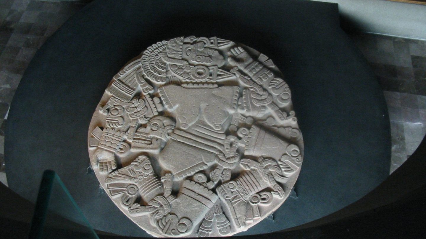 The Coyolxauhqui Disk, a large circular stone carved with the dismembered body of the goddess Coyolxauhqui, discovered by utility workers in downtown Mexico City in 1978 and now displayed at the Museo del Templo Mayor.