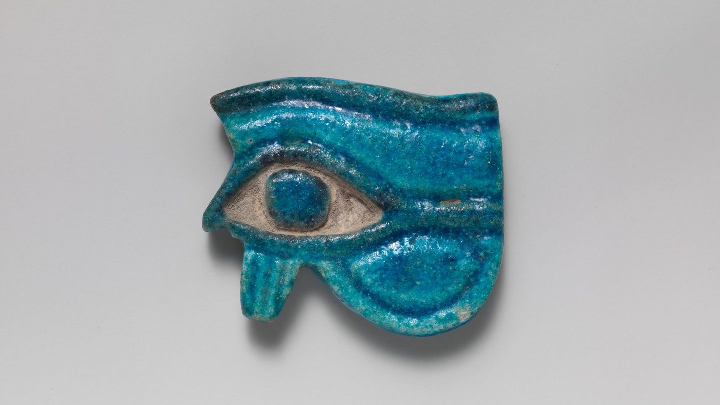 Small blue-glazed faience Wedjat-eye amulet from ancient Egypt, dated circa 1090-900 BC, from the Metropolitan Museum of Art's Cesnola Collection.