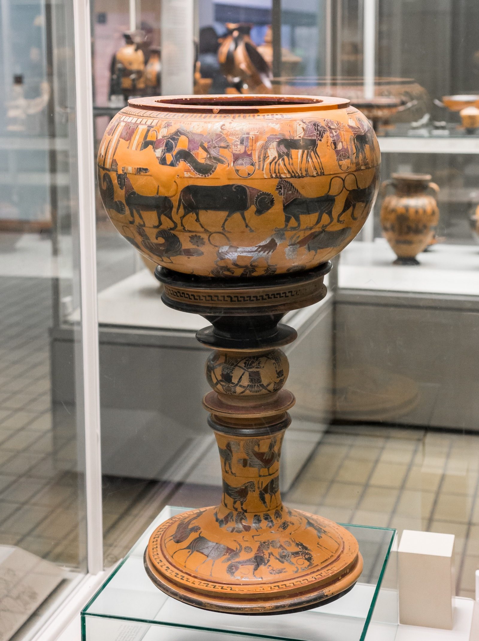 The Sophilos Dinos, an Attic black-figure wine bowl signed by the potter Sophilos and dated to around 580-570 BC, showing part of the procession of gods, each labeled by inscribed name, arriving for the wedding of Peleus and Thetis. British Museum.