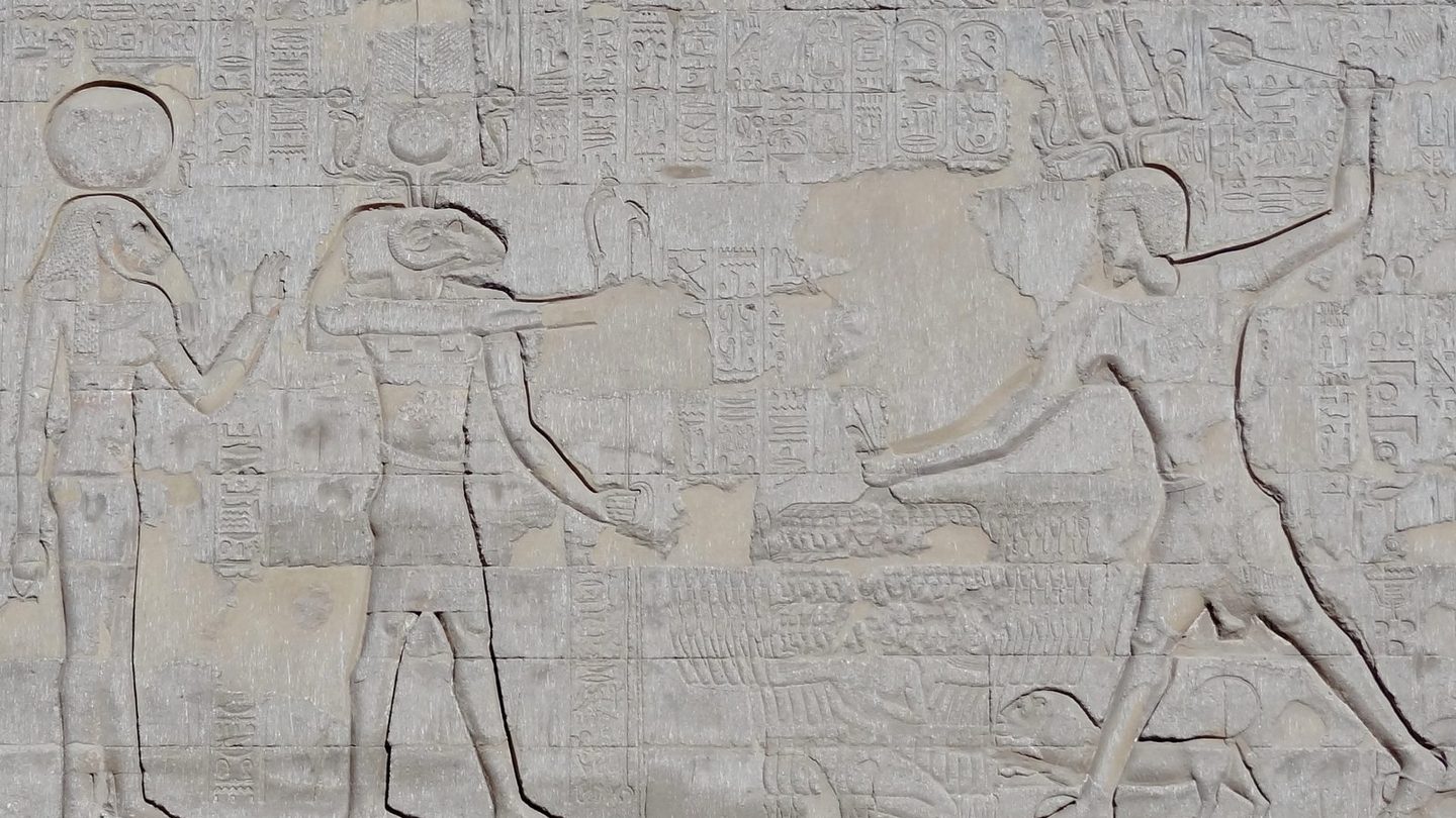A ram-headed relief of the god Khnum, wearing an atef crown, carved into a wall of the Temple of Esna in Egypt.