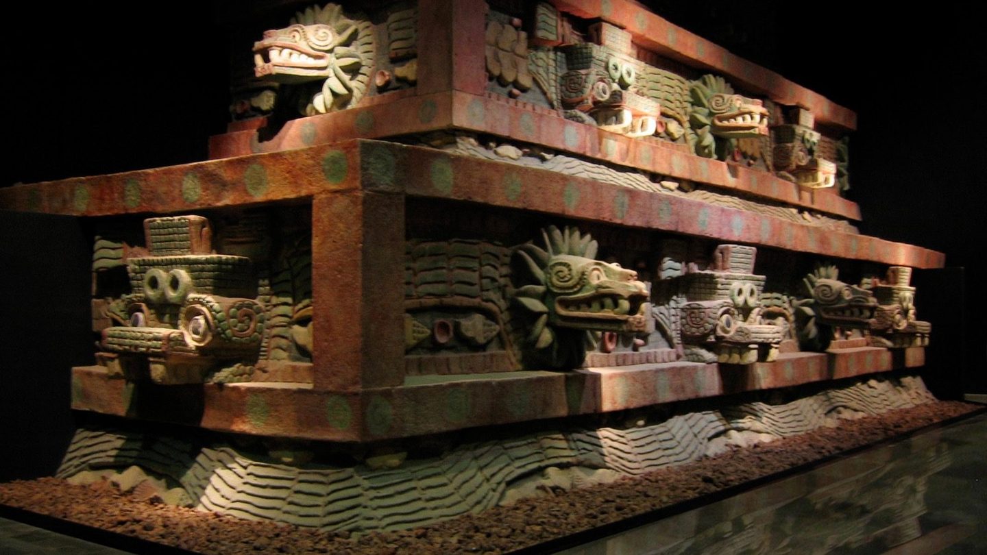 A reconstructed section of the facade of the Temple of the Feathered Serpent from Teotihuacan, showing a carved feathered serpent head, on display at the National Museum of Anthropology in Mexico City.