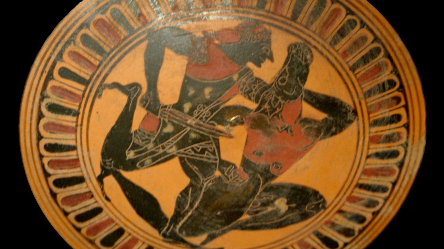 Attic black-figure kylix tondo, about 450-440 BC, showing Theseus gripping the fallen Minotaur by the horn in a wrestling hold, with no weapon visible. Musee du Louvre, F83, Campana Collection.